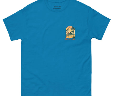 T-shirt bleu vibrant inspiré du Brésil avec un design coloré représentant un paysage tropical, des palmiers et une figure en mouvement, reflétant la joie de vivre et l'énergie festive des plages brésiliennes. Inscription 'Brazilina' en dessous du motif.