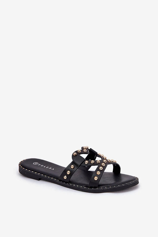 Sandales noires inspirées du Brésil avec détails métalliques dorés, design audacieux et élégant rappelant l'esprit festif des plages brésiliennes, idéales pour l'été.